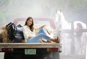 Young woman with her horse in evening sunset light. Outdoor photography with fashion model girl. Lifestyle mood photo