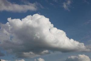 White cumulus clouds in a blue sky with a place for text, Concept lettering and advertising, photo