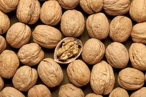 walnut in the shell, peeled walnut. photo