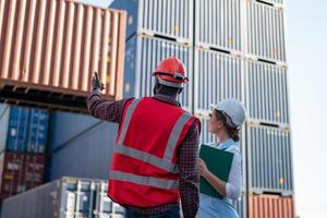 Foreman checking containers in the terminal, at import and export business logistic company. photo