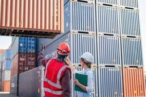 Foreman checking containers in the terminal, at import and export business logistic company. photo