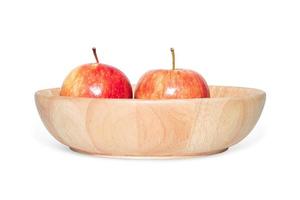 Two red apples placed in a wooden tray on isolated white background. Clipping path object photo