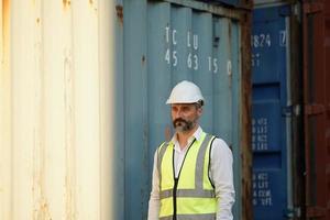 Foreman checking containers in the terminal, at import and export business logistic company. photo