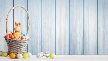 Easter background with colorful easter eggs on wooden background. photo