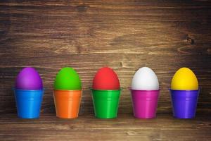 Easter background with colorful easter eggs on wooden background. photo