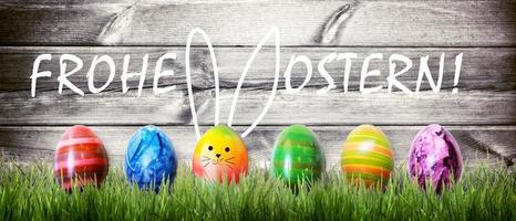 Easter background with colorful easter eggs on wooden background. photo