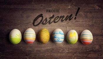 Easter background with colorful easter eggs on wooden background. photo