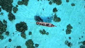 Top view on wooden boat on blue seascape. photo