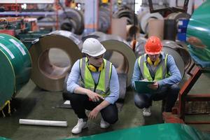 Industry worker Foreman or worker work at factory site check up machine or products in site. Engineer or Technician checking Material or Machine on Plant. Industrial and Factory. photo