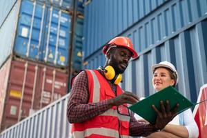 Foreman checking containers in the terminal, at import and export business logistic company. photo