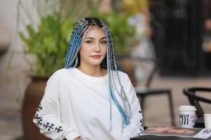 Portrait of Young girl with blue hair, teenage standing on street as urban life. photo