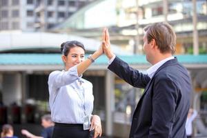 Successful business people standing together widen out showing strong relationship of worker community. A team of businessman and businesswoman expressing a strong group teamwork at the modern office. photo