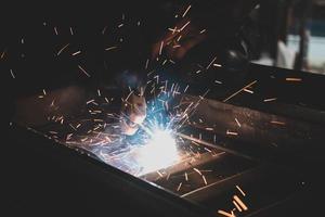 welder, welding automotive part in a car factory photo