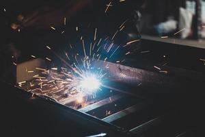 welder, welding automotive part in a car factory photo