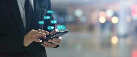 Businessman using smartphone with social network icon , Copy space. Idea for business, online banking, technology, send sms. photo