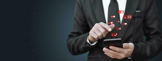 Close-up of businessman hands using mobile smartphone with social media icon. Idea for business, online marketing and technology. photo