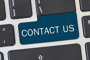 Contact us' button on keyboard. Concept of internet online contact through website. photo
