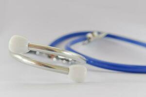 Close-up of blue stethoscope medical on white background. Idea for doctor diagnostic coronavirus disease. photo