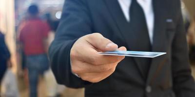 Close-up of businessman hand hold credit card. Selective focus at hands. photo