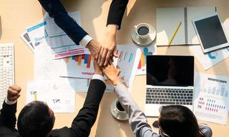Top view on a group of businessman and businesswoman having a meeting and making a business commitment. photo
