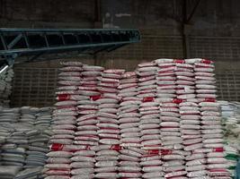 Chemical fertilizer The product stock is packed in sacks, stacked in the warehouse, waiting for delivery. photo