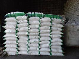 Large jumbo hemp sack White, packed with chemical fertilizer, rice, sugar, placed on a wooden pallet waiting to be delivered to the customer photo