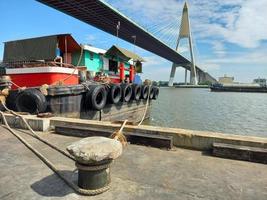 boat, waiting to send products for export and domestic business Transported via water and Blue sky background photo