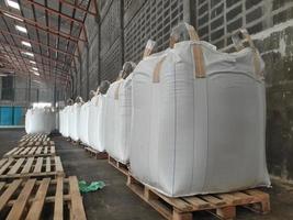 Chemical fertilizer Urea Stock pile jumbo-bag in warehouse waiting for shipment. photo