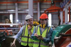 Industry worker Foreman or worker work at factory site check up machine or products in site. Engineer or Technician checking Material or Machine on Plant. Industrial and Factory. photo