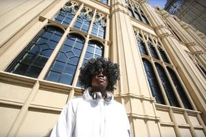 Afro American man having fun walking in city center - Happy young guy enjoying time a sunset outdoor - Millennial generation lifestyle and positive people attitude concept photo