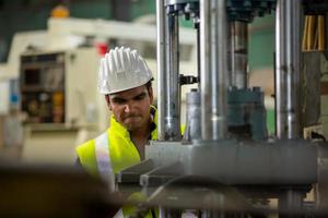 Foreman or worker work at factory site check up machine or products in site. Engineer or Technician checking Material or Machine on Plant. Industrial and Factory. photo