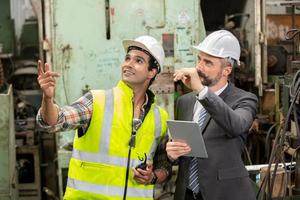 Worker work at factory site check up machine in products line or products in site. Engineer or Technician checking Material or Machine on Plant. Industrial and Factory. photo