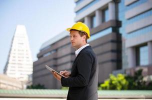 The engineer and business woman checking on clipboard at construction site building. The concept of engineering, construction, city life and future. photo