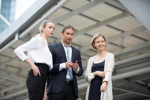 Successful business people standing together widen out showing strong relationship of worker community. A team of businessman and businesswoman expressing a strong group teamwork at the modern office. photo