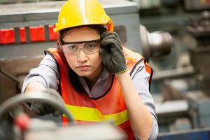 Female Worker work at factory site check up machine in products line or products in site. Engineer or Technician checking Material or Machine on Plant. Industrial and Factory. photo