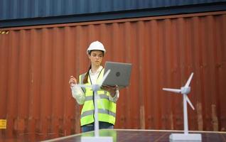 Foreman control loading Containers box from Cargo freight ship for import export. photo