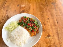 Homemade food, Fried pork cutlet top on stir fried basil, Thai style. photo