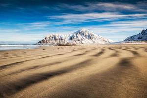 Natural furrow sand with snow mountain and blue sky photo