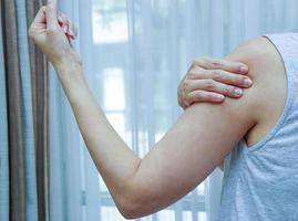 Woman with pain in shoulder and upper arm. photo