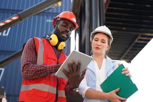 foreman checking containers in the terminal, at import and export business logistic company. photo