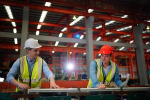 Industry worker Foreman or worker work at factory site check up machine or products in site. Engineer or Technician checking Material or Machine on Plant. Industrial and Factory. photo