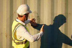 Foreman checking containers in the terminal, at import and export business logistic company. photo