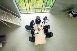 Top view on a group of businessman and businesswoman having a meeting and making a business commitment. photo