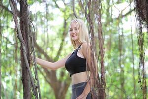 Portrait of a beautiful blonde woman on sportswear enjoy her summertime at the park. photo