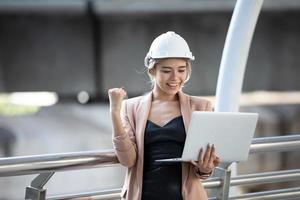 Female construction site engineer with laptop.