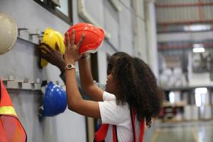 Female worker Foreman or worker work at factory site check up machine or products in site. Engineer or Technician checking Material or Machine on Plant. Industrial and Factory. photo