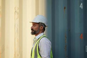 Foreman checking containers in the terminal, at import and export business logistic company. photo