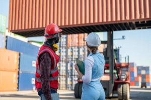 Foreman checking containers in the terminal, at import and export business logistic company. photo
