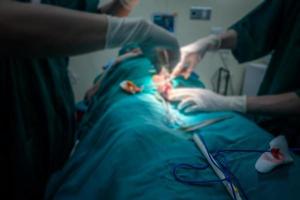 Blurred background of modern operating room at hospital with Group of surgeons in operating room with surgery equipment. Modern medical background photo