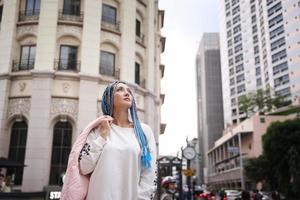 Portrait of Young girl with blue hair, teenage standing on street as urban life.